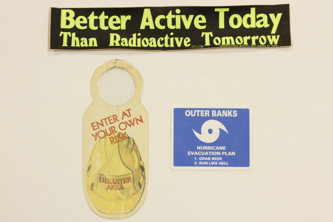 Disaster-themed bumper stickers and doorknob sign