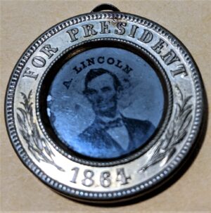 Abraham Lincoln / Andrew Johnson ferrotype button, Lincoln face (recto), 1864, from the collection of Jerome O. Herlihy