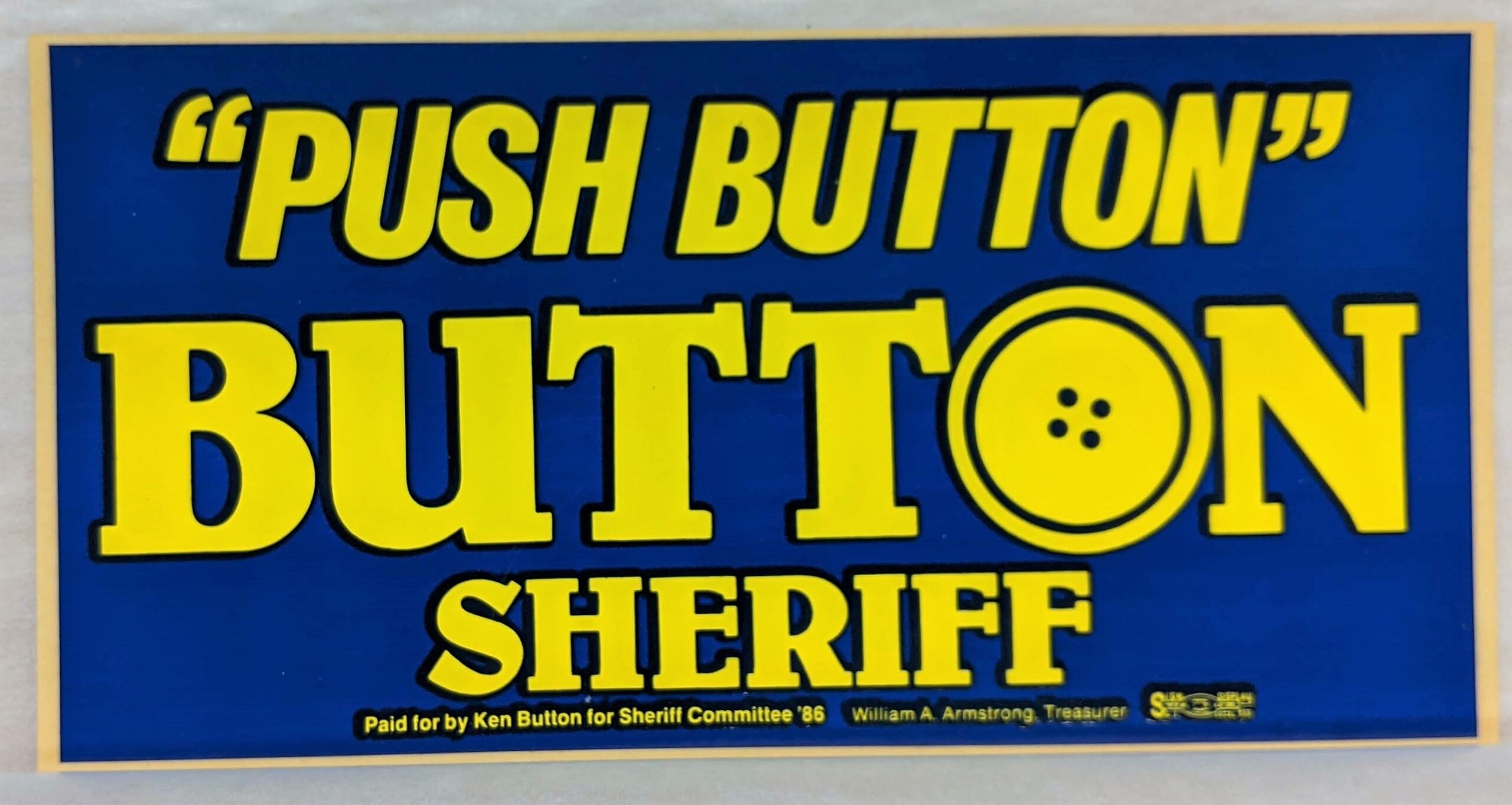 Creator unknown, “‘Push Button’ [Ken] Button for Sheriff” bumper sticker, 1986, from the Jerome O. Herlihy political campaign ephemera collection