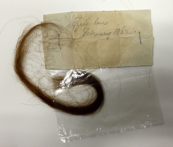 Lock of Elizabeth Siddall’s hair; with attached autograph note by D. G. Rossetti