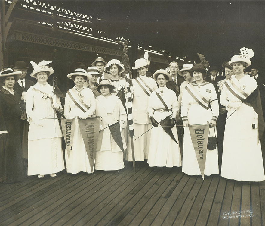 Photograph of group at train station, departing from Wilmington, Delaware, to attend suffrage parade in Washington, D.C., 1914. Wilmington, Delaware [Delmarva] Sunday Morning Star, May 10, 1914. Fascimile image courtesy of the Delaware Historical Society